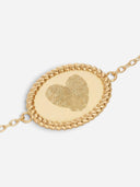 TAYLR gold oval rope bracelet featuring a heart-shaped engraving made from two distinct fingerprints.