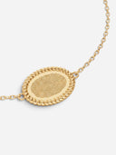 TAYLR gold oval rope bracelet featuring a detailed engraved fingerprint on a polished pendant with a delicate chain