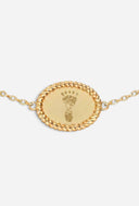 TAYLR gold oval rope bracelet featuring an engraved baby footprint, a sentimental keepsake for new parents.