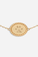 TAYLR gold oval rope-style bracelet featuring a custom engraved pet pawprint as a sentimental memorial keepsake.