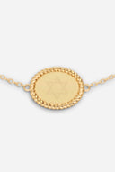TAYLR gold oval rope bracelet featuring an engraved Star of David on a polished surface with delicate rope detailing.