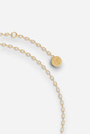 TAYLR gold chain bracelet featuring a delicate oval charm with engraved symbol detail on a light background