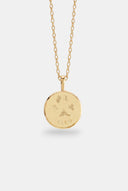 TAYLR gold coin necklace featuring an engraved pawprint and the name Cleo on a delicate chain.