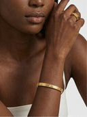 TAYLR 18k gold vermeil ribbed bangle featuring inlaid lab diamonds worn on a model's wrist with a matching ring